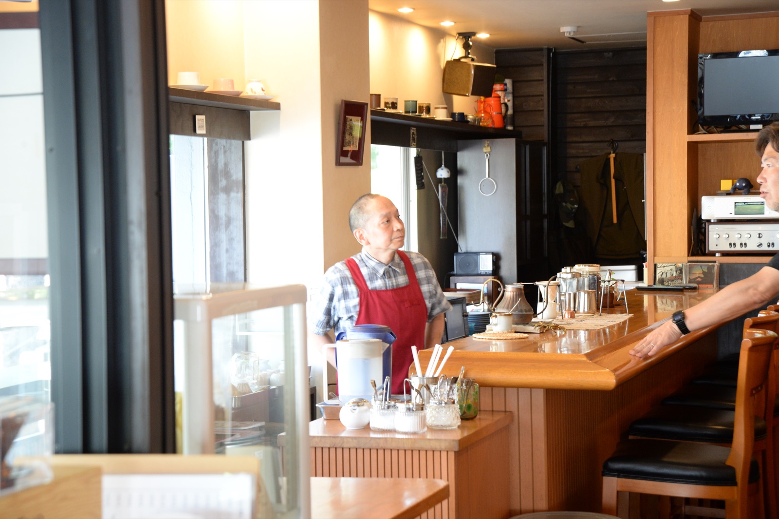 アポニーの店内とカウンターに立つ白石さん