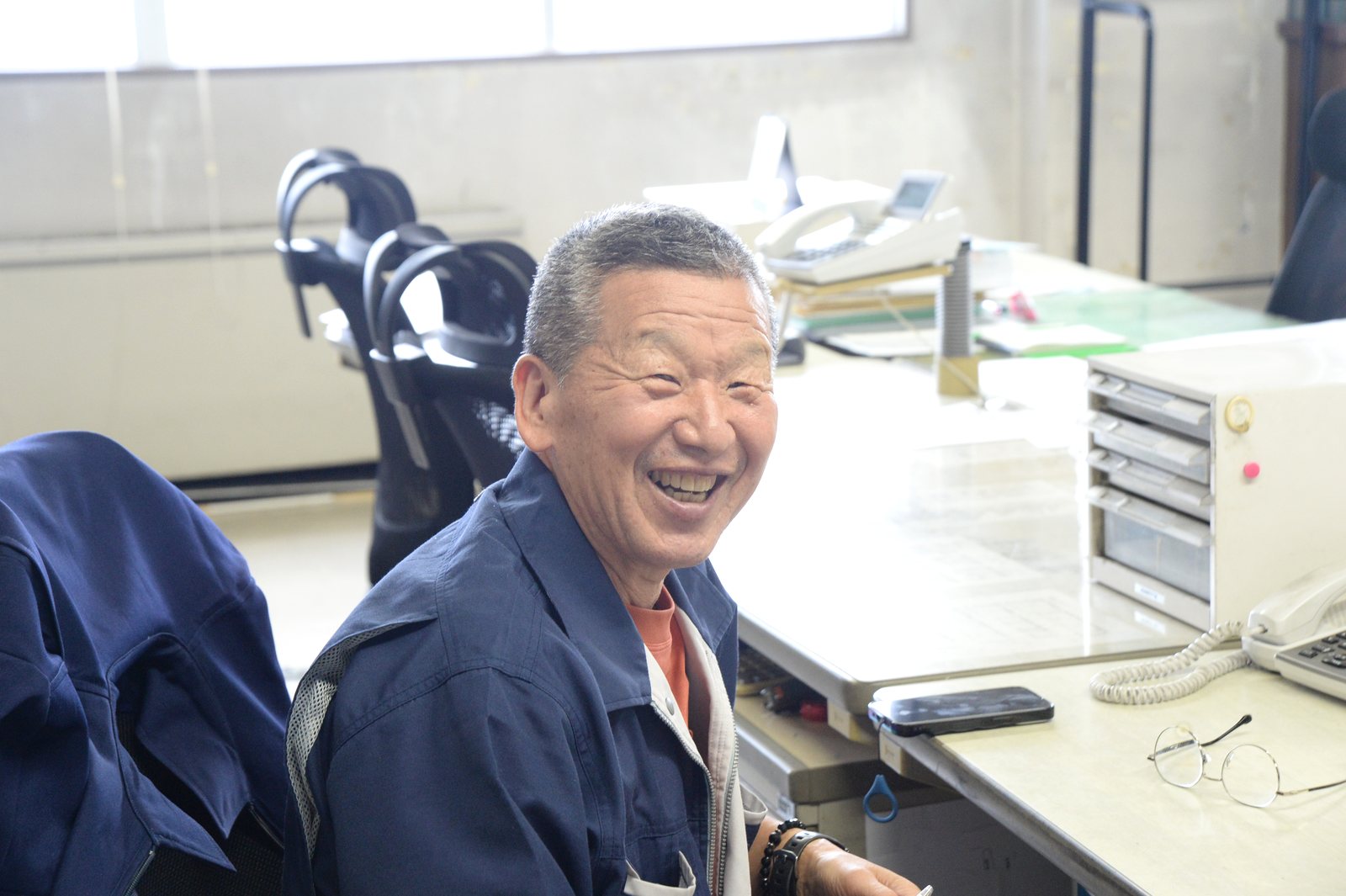 丸今青果の事務所で笑顔を見せる「山の神」