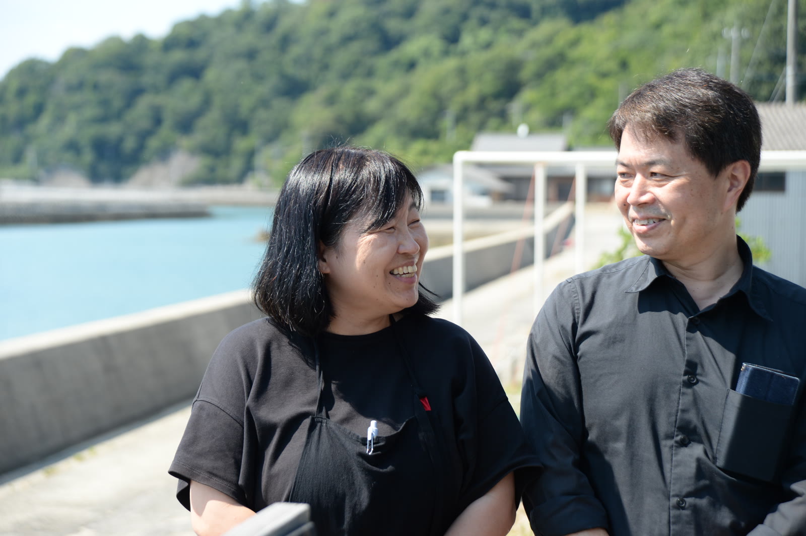 海辺で笑顔を交わす広田裕子さんと俊雄さん